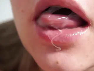 An intense blowjob unfolds up close, lips wrapping eagerly around the shaft before swallowing every drop in a finale of pure satisfaction. She pauses for a teasing breath, the moment stretching with electric anticipation. The smooth glide of tongue against skin creates a sensory highlight, turning the scene into a intimate explosion of desire and fulfillment.