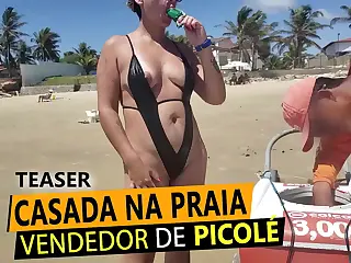 Blonde wife in a thong teases a Popsicle seller on the beach, turning innocent fun into a naughty exchange under the sun, the cool stick against warm lips sparking ideas